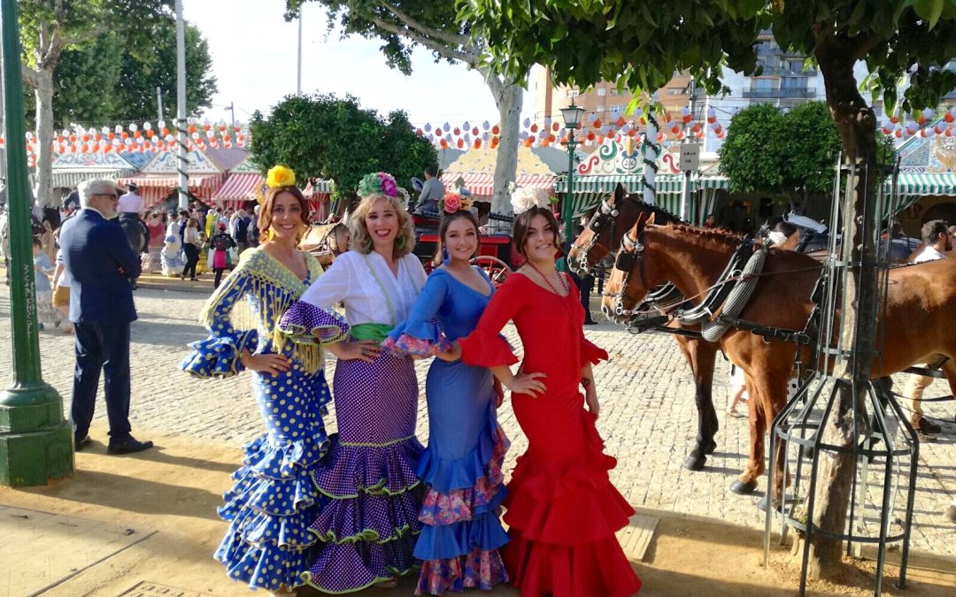 Vier tienermeisjes gekleed in flamencokostuums voor een kermis in Andalusië